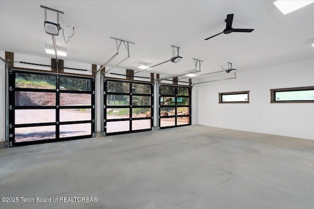5727 Forest Ridge Rd, Victor, ID 83455 - garage featuring a garage door opener and a ceiling fan