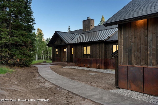 5727 Forest Ridge Rd, Victor, ID 83455 - back of property featuring a standing seam roof, a chimney, and a metal roof