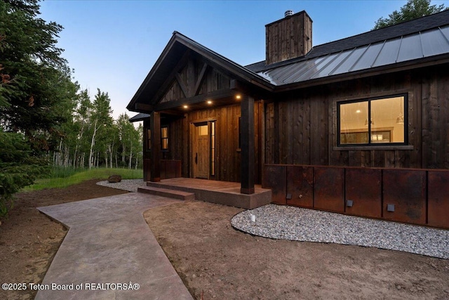 5727 Forest Ridge Rd, Victor, ID 83455 - view of front of property with a chimney, a standing seam roof, a metal roof, and a patio
