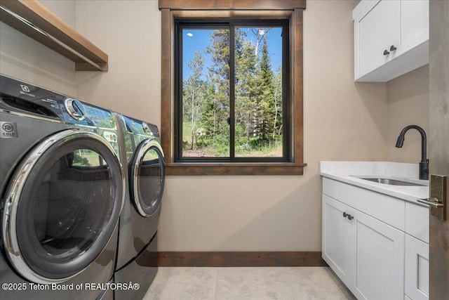 5727 Forest Ridge Rd, Victor, ID 83455 - laundry area featuring separate washer and dryer, cabinet space, healthy amount of natural light, and light tile patterned floors