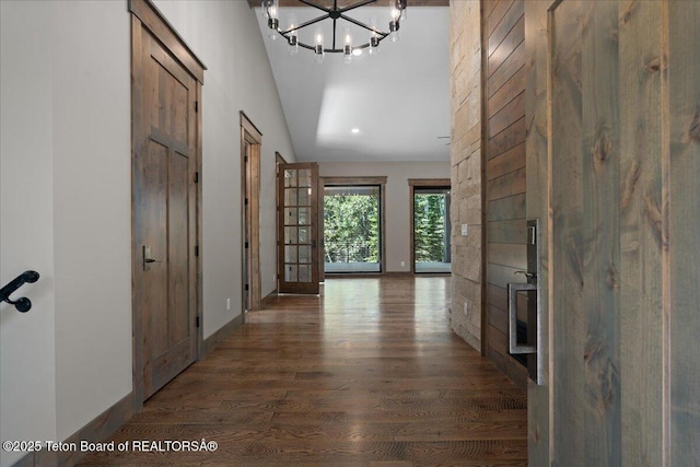 5727 Forest Ridge Rd, Victor, ID 83455 - hall featuring wood finished floors, lofted ceiling, and a chandelier