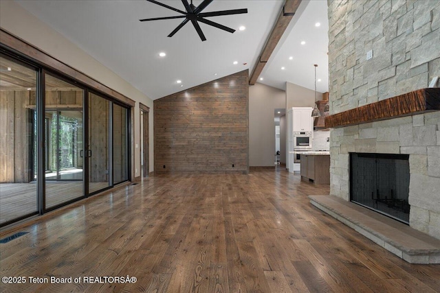 5727 Forest Ridge Rd, Victor, ID 83455 - unfurnished living room featuring beamed ceiling, ceiling fan, wood finished floors, high vaulted ceiling, and a fireplace
