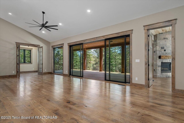 5727 Forest Ridge Rd, Victor, ID 83455 - spare room with ceiling fan, a glass covered fireplace, wood finished floors, recessed lighting, and high vaulted ceiling