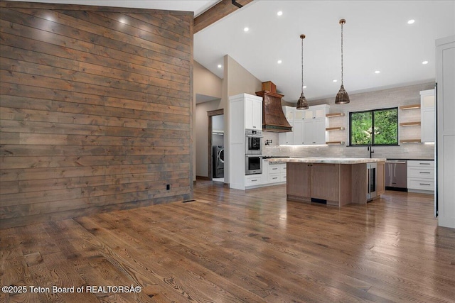 5727 Forest Ridge Rd, Victor, ID 83455 - kitchen featuring open shelves, custom range hood, appliances with stainless steel finishes, decorative backsplash, and dark wood-type flooring