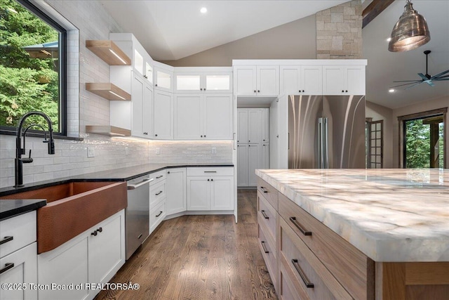 5727 Forest Ridge Rd, Victor, ID 83455 - kitchen featuring lofted ceiling, appliances with stainless steel finishes, open shelves, healthy amount of natural light, and dark wood finished floors