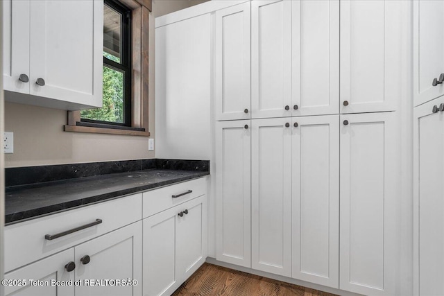5727 Forest Ridge Rd, Victor, ID 83455 - kitchen with white cabinetry and dark stone counters