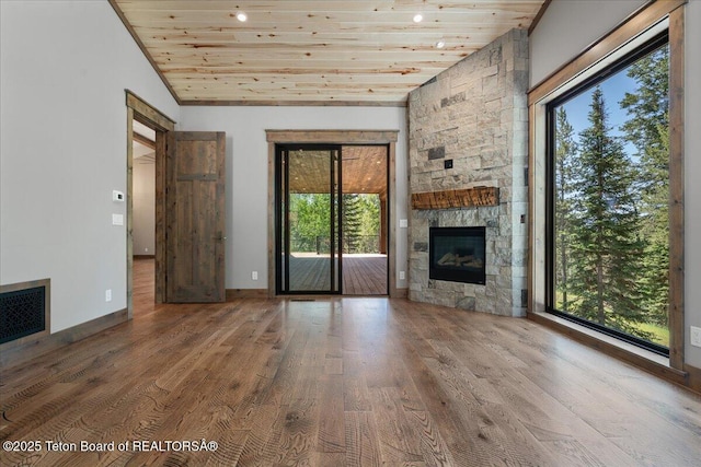 5727 Forest Ridge Rd, Victor, ID 83455 - unfurnished living room featuring a fireplace, wood finished floors, and wood ceiling