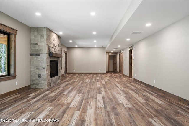 5727 Forest Ridge Rd, Victor, ID 83455 - unfurnished living room featuring wood finished floors, recessed lighting, and a stone fireplace