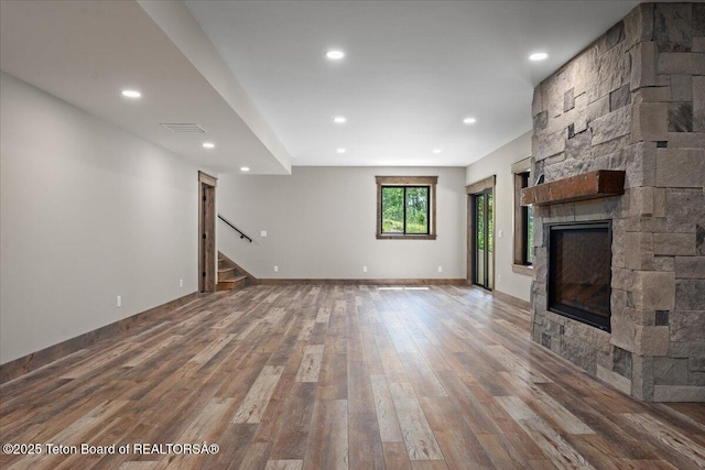 5727 Forest Ridge Rd, Victor, ID 83455 - unfurnished living room featuring a fireplace, wood finished floors, stairs, and recessed lighting