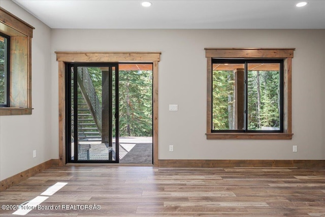 5727 Forest Ridge Rd, Victor, ID 83455 - empty room featuring healthy amount of natural light, wood finished floors, and recessed lighting