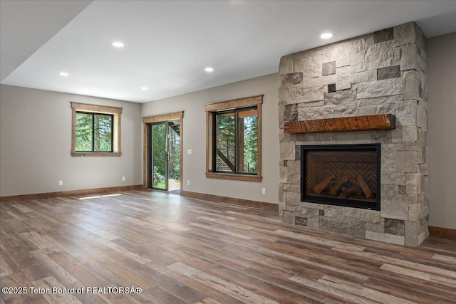 5727 Forest Ridge Rd, Victor, ID 83455 - unfurnished living room featuring wood finished floors, a fireplace, and recessed lighting