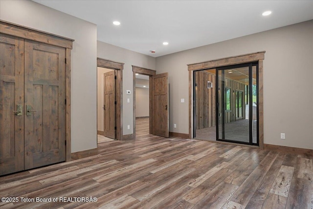 5727 Forest Ridge Rd, Victor, ID 83455 - unfurnished bedroom featuring access to exterior, wood finished floors, and recessed lighting