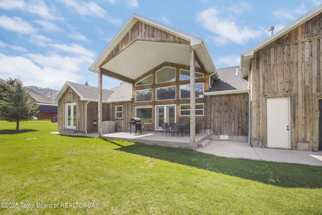 405 Vista Dr, Star Valley Ranch, WY 83127 - back of house with french doors, a yard, a patio area, a shingled roof, and board and batten siding