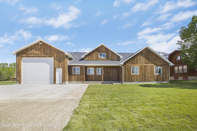 405 Vista Dr, Star Valley Ranch, WY 83127 - view of front of property featuring concrete driveway, board and batten siding, a front yard, an attached garage, and roof with shingles