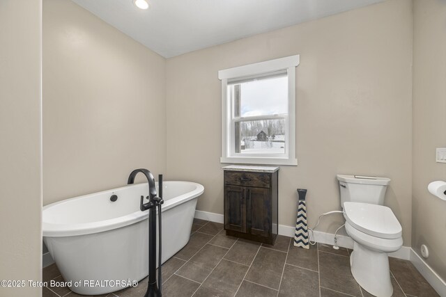 405 Vista Dr, Star Valley Ranch, WY 83127 - full bath featuring a freestanding bath, tile patterned flooring, toilet, and baseboards