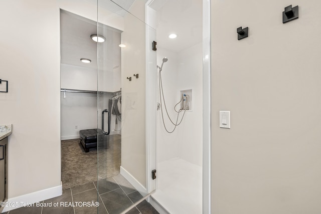 405 Vista Dr, Star Valley Ranch, WY 83127 - full bath featuring baseboards, a shower stall, vanity, and tile patterned floors
