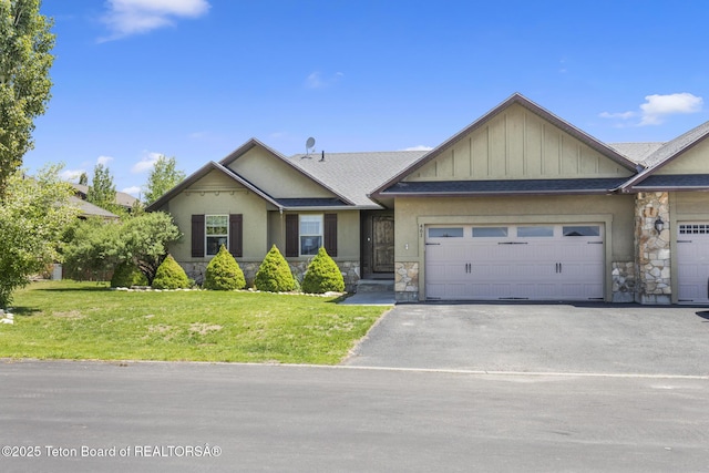 461 Booshway St, Driggs, ID 83422 - view of front of property featuring stone siding, driveway, a front lawn, a garage, and roof with shingles