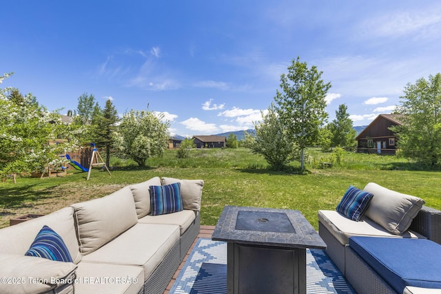 461 Booshway St, Driggs, ID 83422 - view of patio / terrace with an outdoor living space with a fire pit and a playground