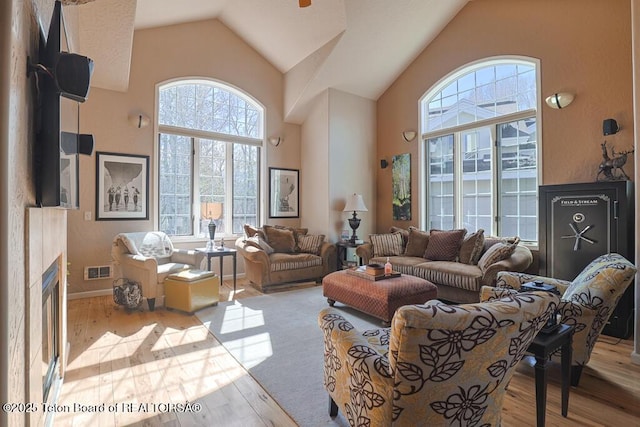 165 Cobble Creek Ln, Driggs, ID 83422 - living area featuring wood finished floors, high vaulted ceiling, a fireplace, and baseboards