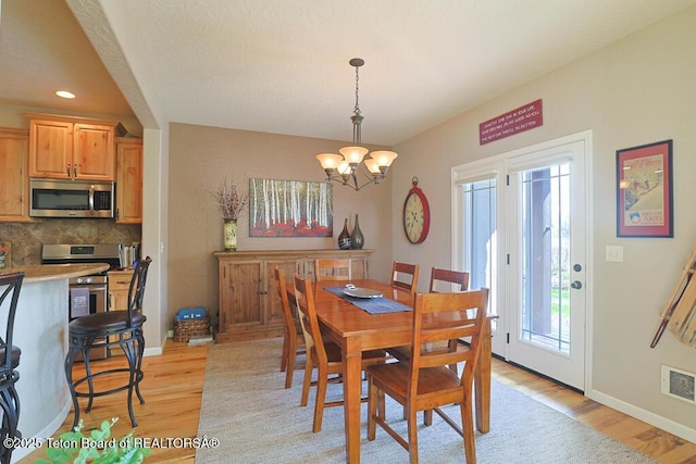 165 Cobble Creek Ln, Driggs, ID 83422 - dining space featuring light wood finished floors, a chandelier, baseboards, and recessed lighting