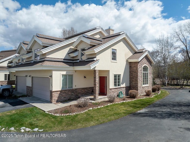 165 Cobble Creek Ln, Driggs, ID 83422 - view of front facade with stucco siding, stone siding, and driveway
