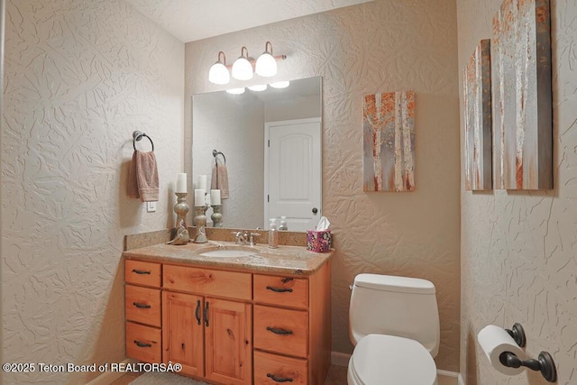 165 Cobble Creek Ln, Driggs, ID 83422 - bathroom featuring vanity, a textured wall, and toilet