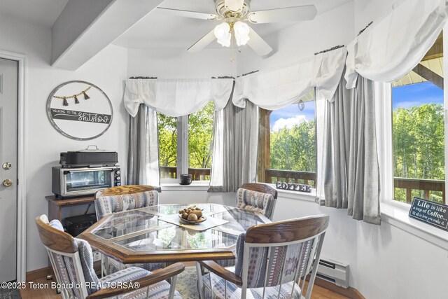 279 Vista E Dr, Star Valley Ranch, WY 83127 - dining space featuring a baseboard heating unit, a ceiling fan, wood finished floors, and baseboards