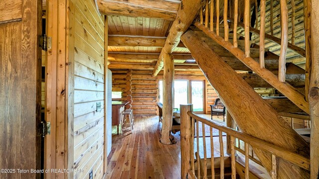 10559 Rammell Mountain Rd, Tetonia, ID 83452 - hall with log walls, wood-type flooring, and wooden ceiling with exposed beams