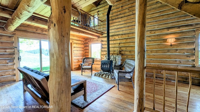 10559 Rammell Mountain Rd, Tetonia, ID 83452 - living room featuring wooden ceiling, a wood stove, log walls, and wood-type flooring