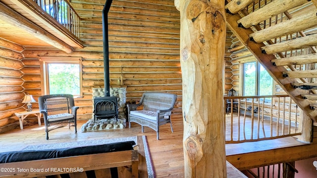 10559 Rammell Mountain Rd, Tetonia, ID 83452 - sitting room featuring rustic walls, hardwood / wood-style flooring, a wood stove, and healthy amount of natural light