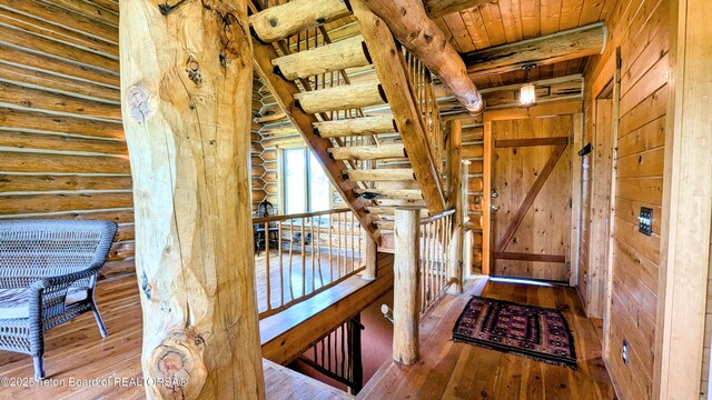 10559 Rammell Mountain Rd, Tetonia, ID 83452 - entryway with log walls, hardwood / wood-style flooring, and wood ceiling with exposed beams