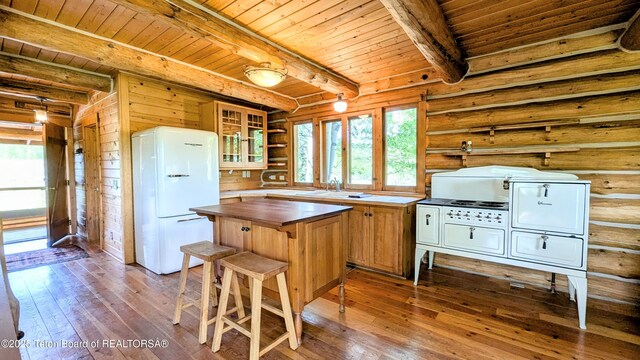 10559 Rammell Mountain Rd, Tetonia, ID 83452 - kitchen with freestanding refrigerator, wood counters, wooden ceiling with exposed beams, hardwood / wood-style floors, and healthy amount of natural light