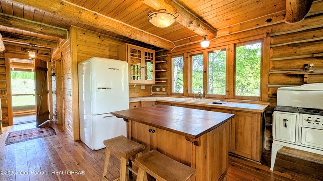 10559 Rammell Mountain Rd, Tetonia, ID 83452 - kitchen with freestanding refrigerator, butcher block countertops, plenty of natural light, wooden ceiling with exposed beams, and a sink