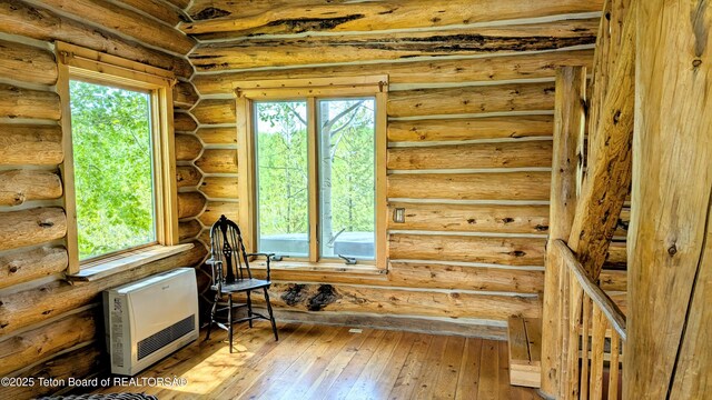 10559 Rammell Mountain Rd, Tetonia, ID 83452 - office area featuring plenty of natural light, heating unit, light wood finished floors, and rustic walls