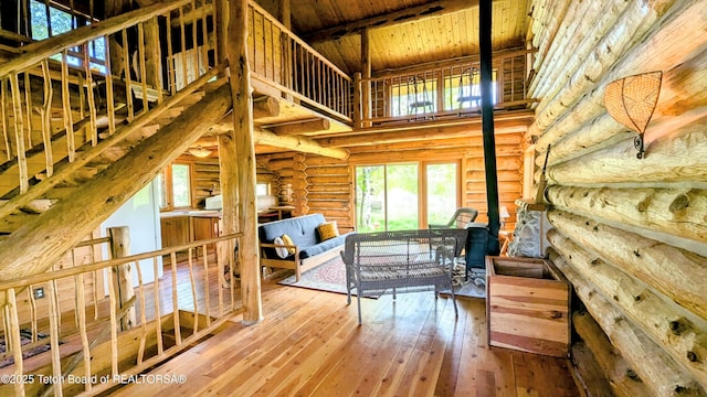 10559 Rammell Mountain Rd, Tetonia, ID 83452 - living area featuring log walls, hardwood / wood-style floors, a high ceiling, and wood ceiling