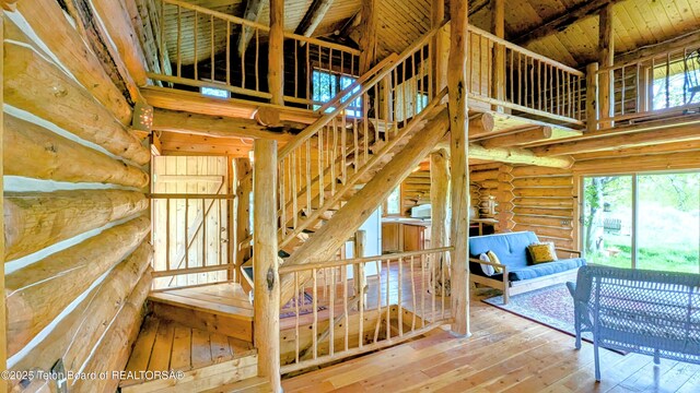 10559 Rammell Mountain Rd, Tetonia, ID 83452 - stairway featuring hardwood / wood-style flooring, rustic walls, a high ceiling, and wooden ceiling