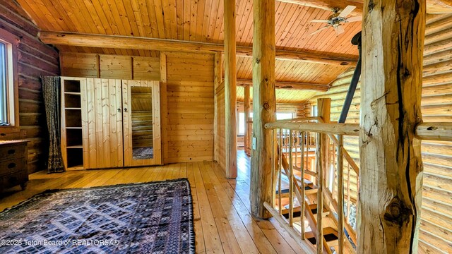 10559 Rammell Mountain Rd, Tetonia, ID 83452 - hall with wood ceiling, hardwood / wood-style floors, log walls, and an upstairs landing