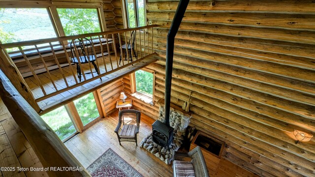 10559 Rammell Mountain Rd, Tetonia, ID 83452 - stairway featuring a wood stove, hardwood / wood-style floors, and log walls
