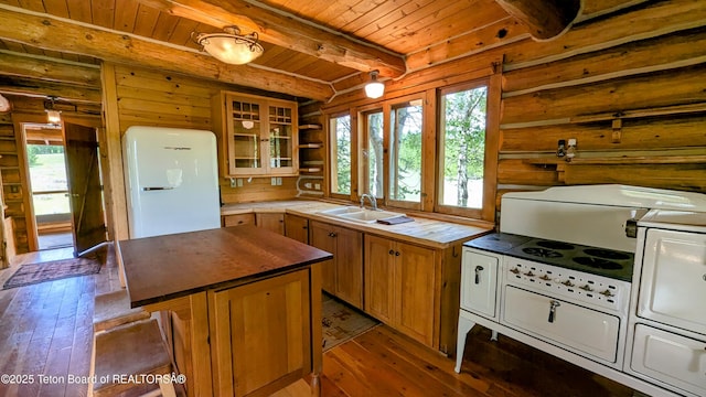 10559 Rammell Mountain Rd, Tetonia, ID 83452 - kitchen with butcher block counters, freestanding refrigerator, healthy amount of natural light, wooden ceiling with exposed beams, and light wood-style flooring