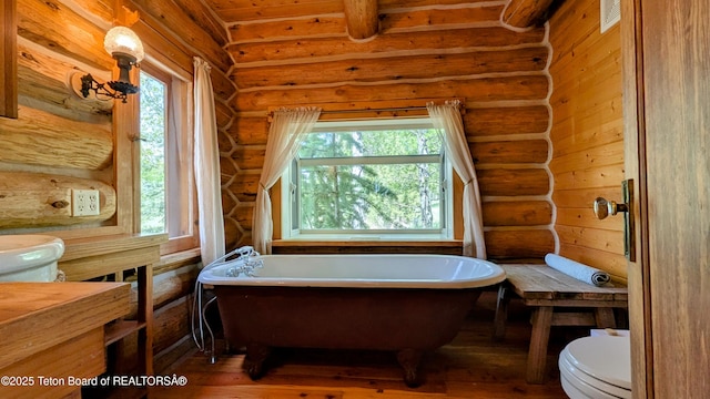 10559 Rammell Mountain Rd, Tetonia, ID 83452 - full bath featuring toilet, log walls, hardwood / wood-style flooring, and a freestanding bath