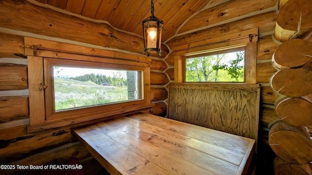 10559 Rammell Mountain Rd, Tetonia, ID 83452 - unfurnished dining area featuring wooden ceiling, vaulted ceiling, and log walls