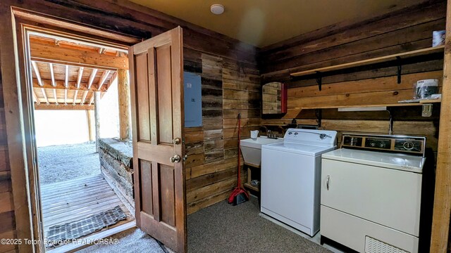 10559 Rammell Mountain Rd, Tetonia, ID 83452 - laundry area featuring wood walls, washer and clothes dryer, electric panel, and carpet floors