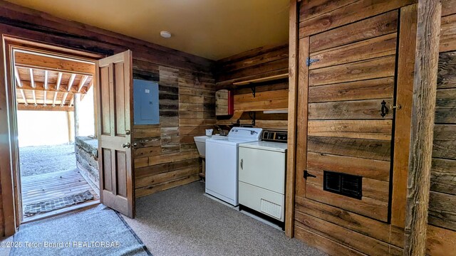 10559 Rammell Mountain Rd, Tetonia, ID 83452 - laundry area featuring electric panel, wooden walls, washer and clothes dryer, and carpet floors