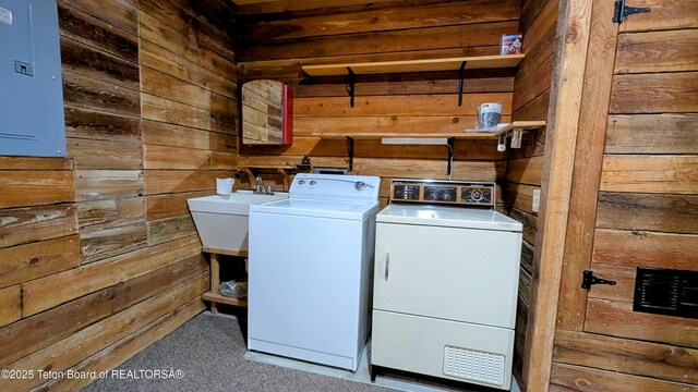 10559 Rammell Mountain Rd, Tetonia, ID 83452 - washroom with wooden walls, washing machine and dryer, electric panel, and carpet floors