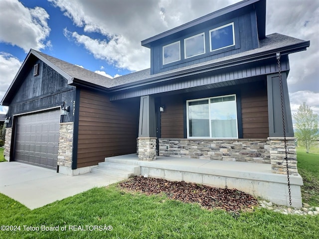 2929 Iron Wood Dr, Driggs, ID 83422 - view of front of home with a porch, stone siding, and an attached garage