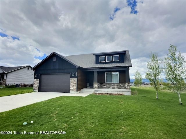 2929 Iron Wood Dr, Driggs, ID 83422 - view of front facade with a garage, a front lawn, stone siding, a porch, and concrete driveway
