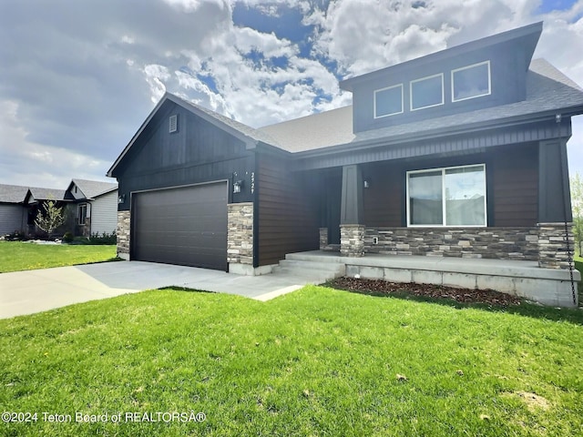 2929 Iron Wood Dr, Driggs, ID 83422 - view of front facade featuring stone siding, covered porch, a garage, a front yard, and driveway