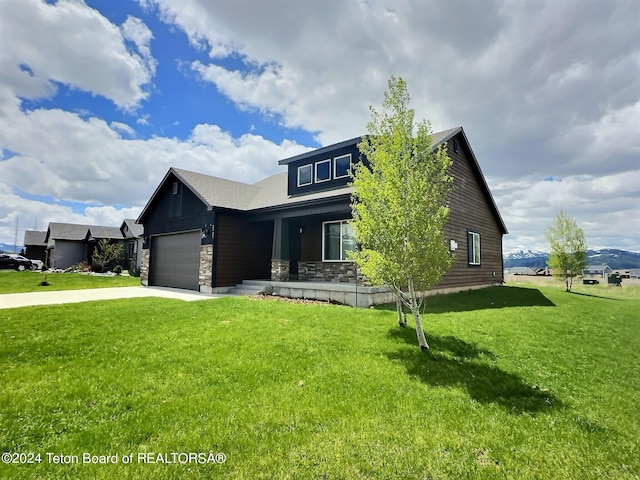 2929 Iron Wood Dr, Driggs, ID 83422 - view of front of home with stone siding, an attached garage, a front yard, and driveway