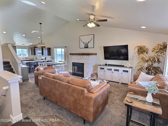2929 Iron Wood Dr, Driggs, ID 83422 - carpeted living area with ceiling fan, recessed lighting, a stone fireplace, stairs, and high vaulted ceiling