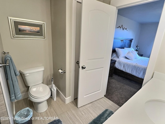 2929 Iron Wood Dr, Driggs, ID 83422 - ensuite bathroom featuring toilet, baseboards, and wood tiled floors